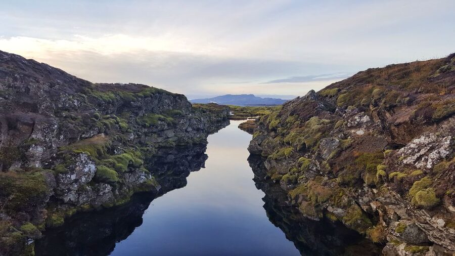 From Reykjavik: Silfra Snorkeling with Free Photos - Entering Silfra and floating through the fissure
