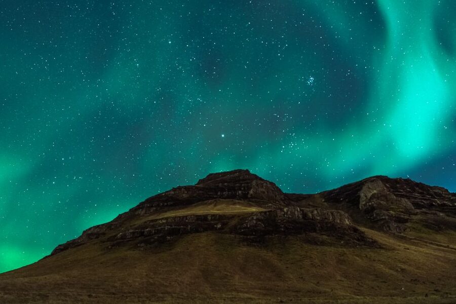 Reykjavik: Northern Lights Group Tour with Photos - Hot chocolate, cold air, and the gear you need